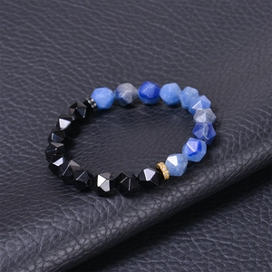 Macro view of 10mm faceted blue agate beads with zircon-set gold and silver metal spacers