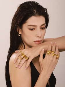 Close-up of minimalist PVD 18K gold plated stainless steel rings styled on fingers