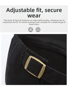 Detail of adjustable bronze metal buckle on black baseball cap for custom fit sizing