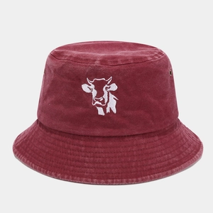 Detail of burgundy washed cotton bucket hat featuring white cow head embroidery and vent