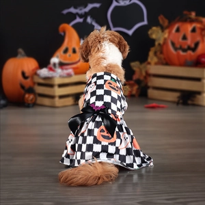 Detail view of Halloween pet dress with pumpkin prints and a black ribbon bow on dog