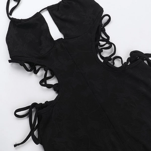Macro detail of black lace bodysuit with cutout design and elegant side lace-up ties