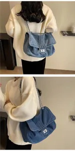 Detail of blue denim shoulder bag with silver turn-lock clasp and metal chain strap