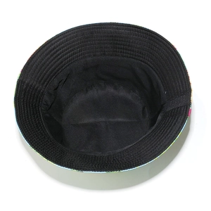 Detail view showing black fabric interior and fine stitching of a banana leaf bucket hat