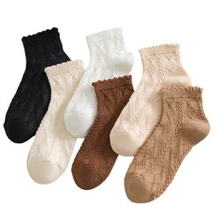 Women's cotton ankle socks with ruffle cuffs and cable knit texture in six neutral colors