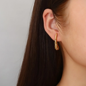 Elegant 18K gold-plated teardrop earrings with zircons shown on a model