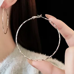 Sparkling silver round hoop earrings with minimalist geometric faceted twist design