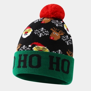 Christmas knit beanie featuring reindeer and snowflake patterns with a red pom-pom