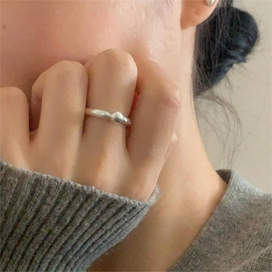 Lifestyle shot of a minimalist 925 sterling silver beaded open ring on a model hand