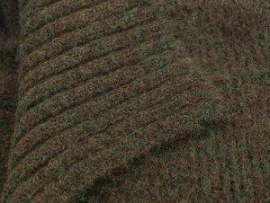 Macro texture of chunky rib knit fabric in dark green and brown mélange yarn