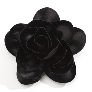 Detailed view of the layered black satin rose brooch with realistic fabric petals
