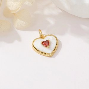 Detail of heart pendant with red gemstone and white inlay for DIY jewelry making