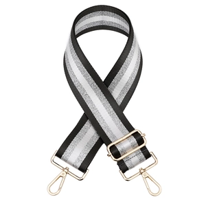 Close-up of adjustable striped handbag strap with silver glitter thread and gold metal hooks