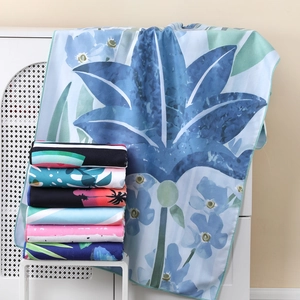 Absorbent quick-dry beach towel with blue leaf prints and assorted patterns stack
