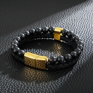 Detail of double-layer men's bracelet with black stone beads and woven leather strap