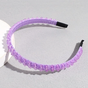 Detailed view of handmade purple beaded headband with transparent crystals and end caps