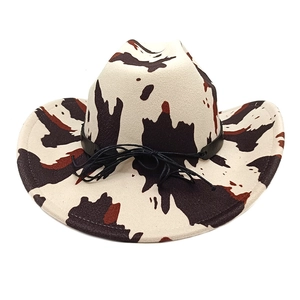 Detail of cow print western cowboy hat with black leather band and wide brim