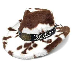 Detail of western cow print cowboy hat with plush texture and bronze star emblem