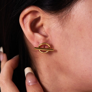Close-up of model wearing 18K gold plated irregular stainless steel toggle earrings
