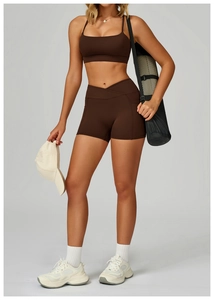 Deep brown yoga set featuring cross-waist shorts and sports bra with seamless pockets