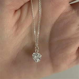 925 sterling silver necklace with heart-shaped zircon pendant held in hand