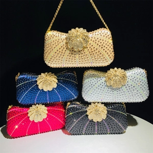 Detailed view of luxury evening clutch bags with sparkling rhinestones and floral metal clasps