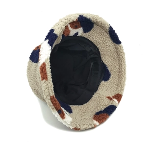 Detail view of the fuzzy bucket hat interior with adjustable black drawstrings for fit