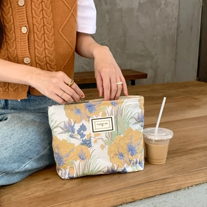 Vintage floral brocade cosmetic bag with zipper and Pleasant Time label for travel storage