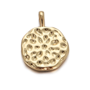 Macro view of gold hammered round pendant with textured surface for DIY jewelry making