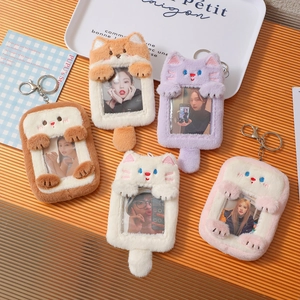 Close-up of colorful plush animal photocard holders with metal keychains in various colors