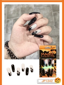 Detail of Halloween press-on nails featuring black and white tombstones and cross designs