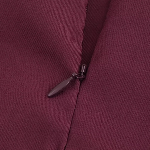 Macro detail of wine red sleeveless top showing invisible zipper and twill fabric