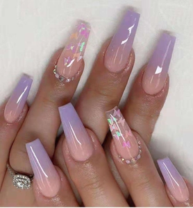 Long coffin press-on nails with purple gradient, butterfly prints, and sparkling rhinestones