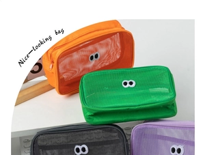 Close-up of colorful mesh makeup bags with eye patches and zipper closure detail