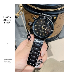 Close-up of dazzling black steel quartz watch featuring three sub-dials and gold markers