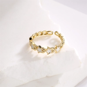 Detail of gold open ring with four white enamel stars and chain link band structure