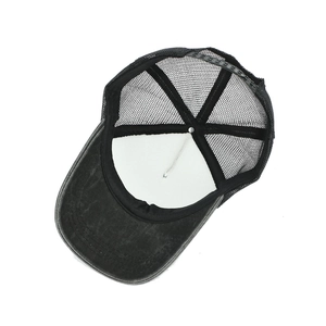 Faded black washed cotton trucker hat with breathable mesh back and adjustable strap