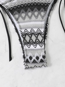 Macro view of geometric pattern bikini bottom with adjustable side ties and knit texture