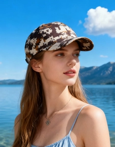 Outdoor close-up of a digital camo baseball cap featuring brown and beige camouflage patterns