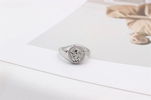 Detail shot of vintage silver cupid angel relief on a polished titanium steel ring