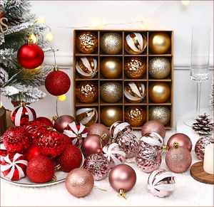 Detail of Christmas tree ornaments featuring matte and glitter textures in a gift box