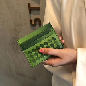 Slim green woven sheepskin leather card holder with multiple slots shown in hand