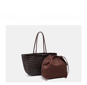 Detail view of a dark brown woven leather tote with its matching drawstring inner bag