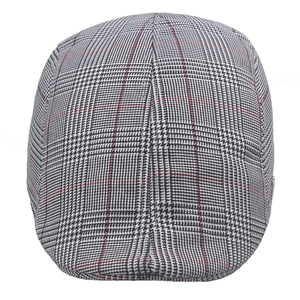 Detail of plaid beret hat with grey Glen Check pattern and red accent stitching