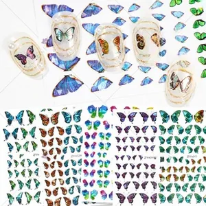 Detail of holographic butterfly nail art stickers showing laser gold and silver textures