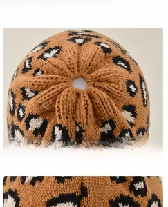Detail view of the knit leopard ponytail hat featuring an elastic hair opening at the top