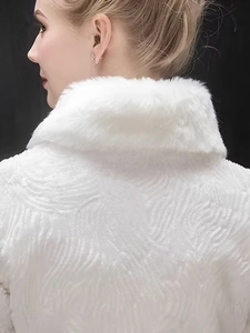 Macro detail of bridal white faux fur shawl showing premium wavy texture and high neck collar