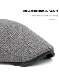 Macro shot of grey knitted beret featuring a foldable wide brim for face contouring