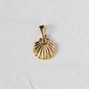 Macro view of shell-shaped 18K gold plated titanium pendant with radial texture