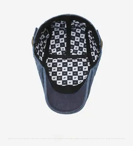 Detail of the navy denim hat featuring a checkered inner lining with IN pattern logo